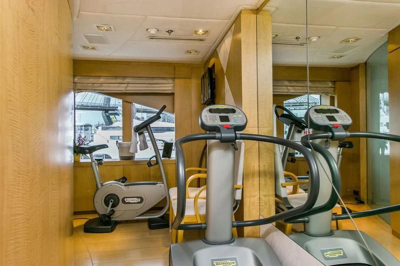 a gym with equipment aboard BACA Yacht for Charter