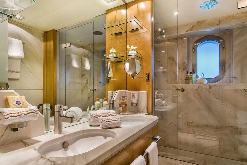 a bathroom with a large mirror aboard BACA Yacht for Charter