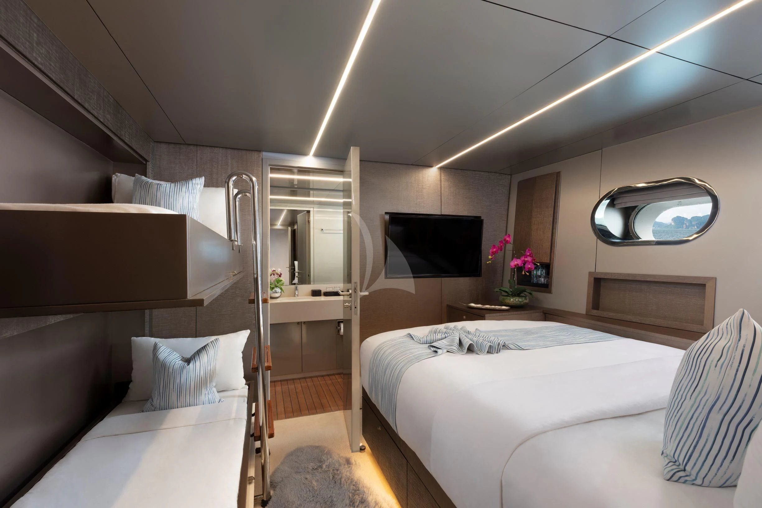 a room with a bed and a television aboard OCEAN EMERALD Yacht for Sale
