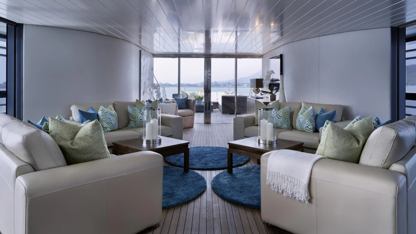 a living room with white couches and a coffee table aboard OCEAN EMERALD Yacht for Sale