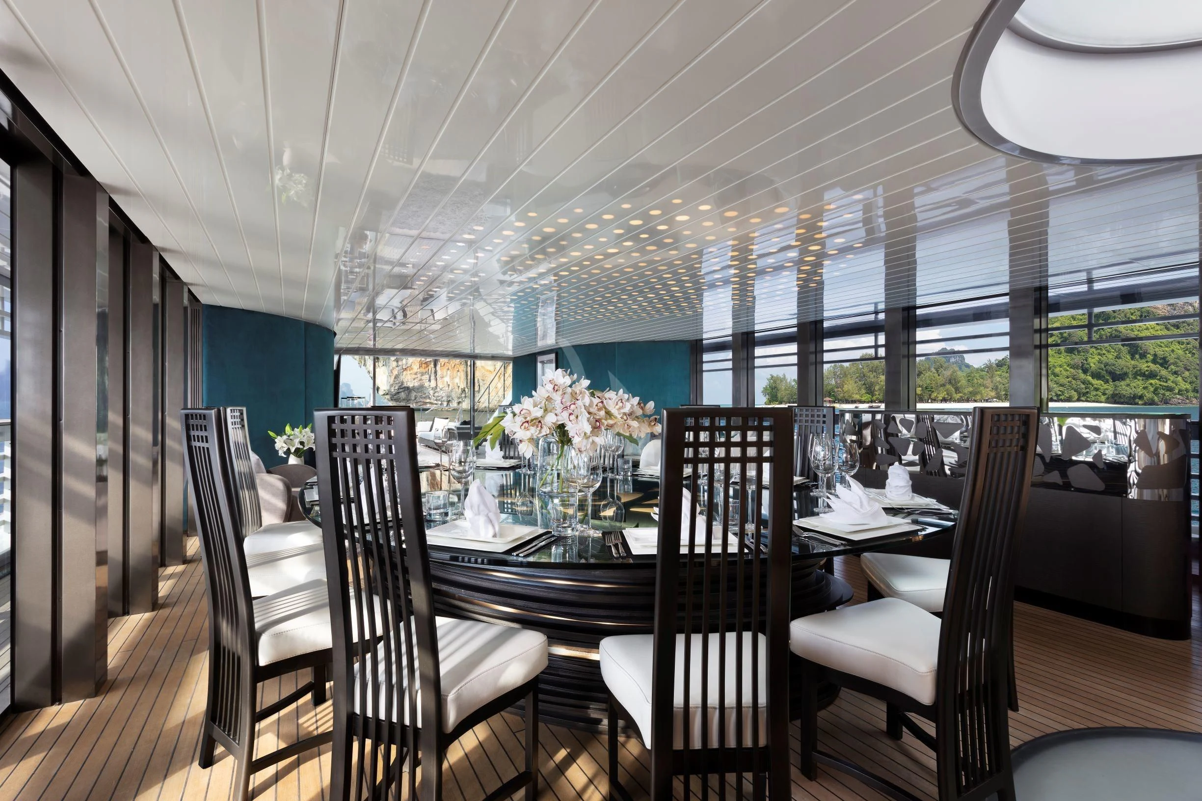 a dining room with a table and chairs aboard OCEAN EMERALD Yacht for Sale