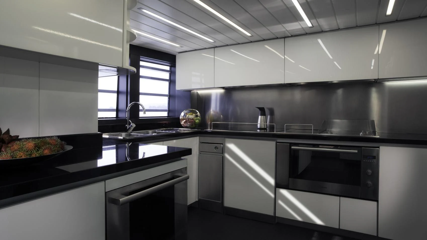 a kitchen with black and white cabinets aboard OCEAN EMERALD Yacht for Sale
