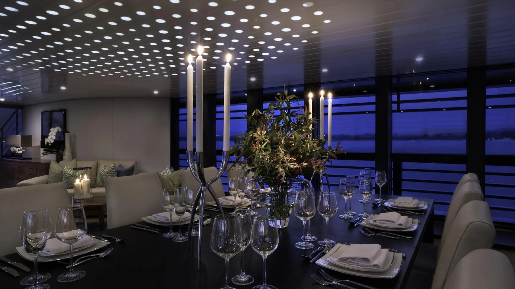 a large table with many glasses and plates on it aboard OCEAN EMERALD Yacht for Sale