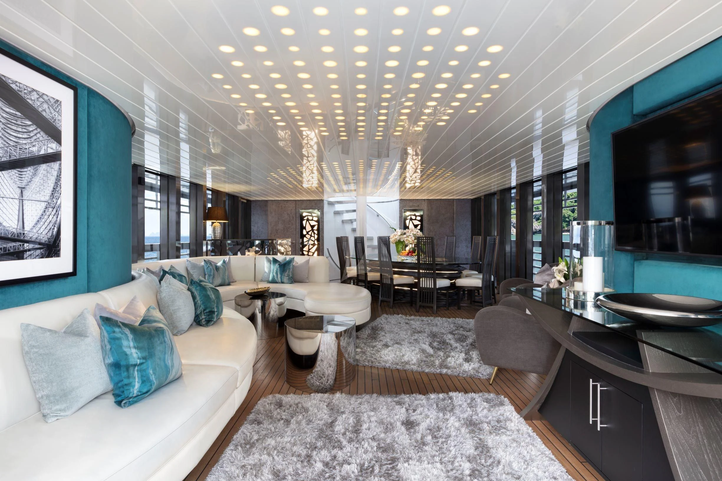 a living room with a large couch and a large mirror aboard OCEAN EMERALD Yacht for Sale