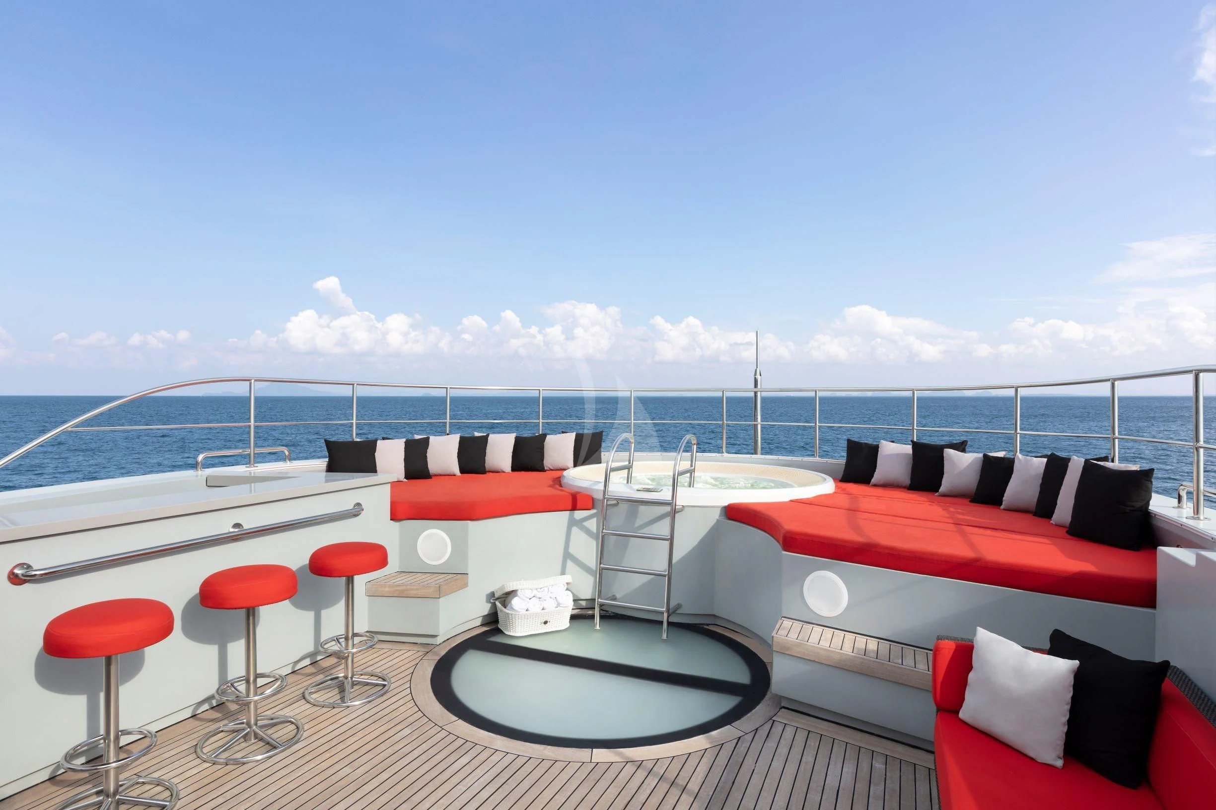 a room with a bed and chairs aboard OCEAN EMERALD Yacht for Sale