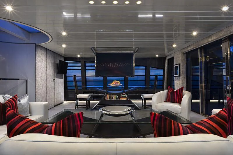 a living room with a large screen aboard OCEAN EMERALD Yacht for Sale