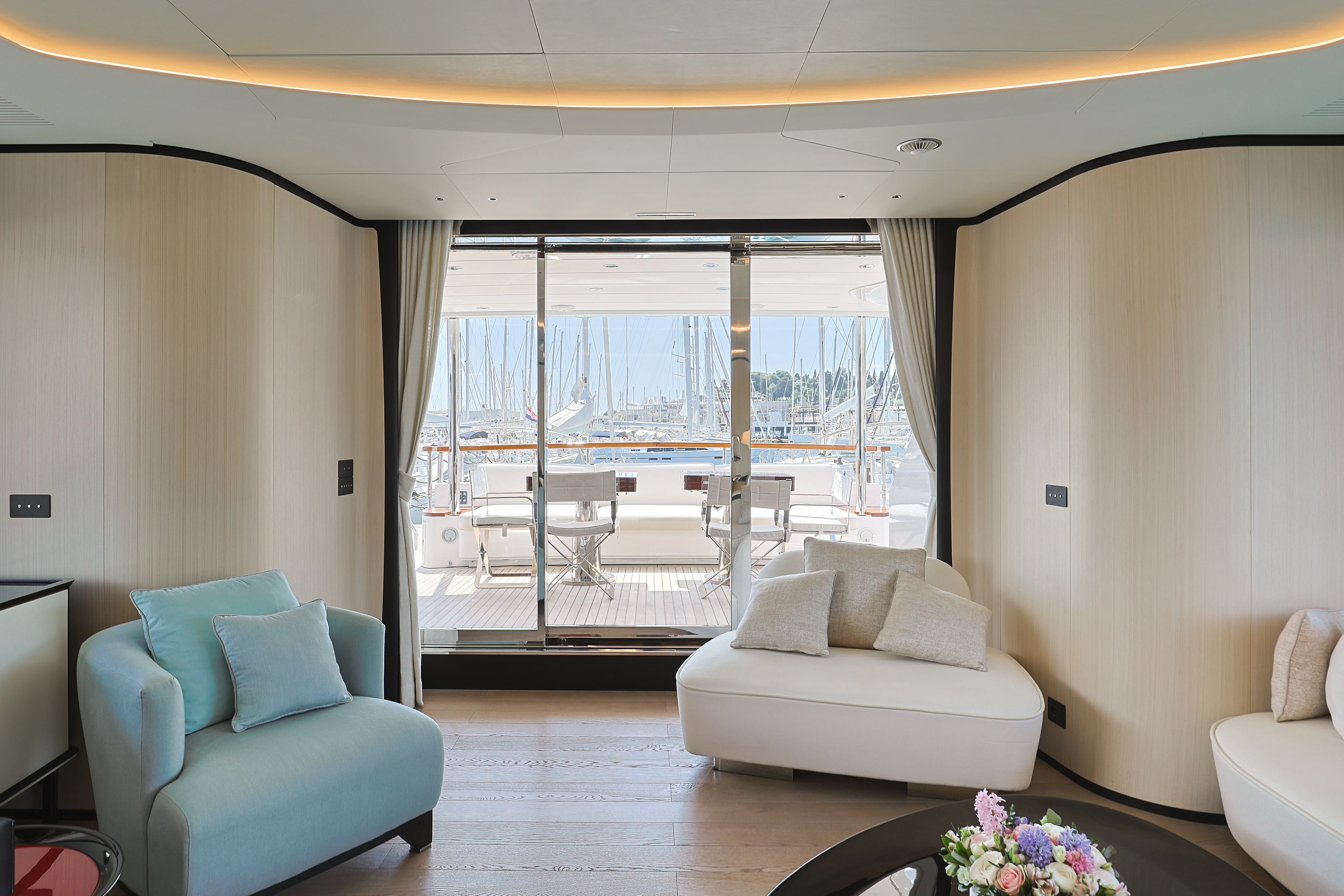 a living room with a large glass door aboard BELLA VITA Yacht for Charter