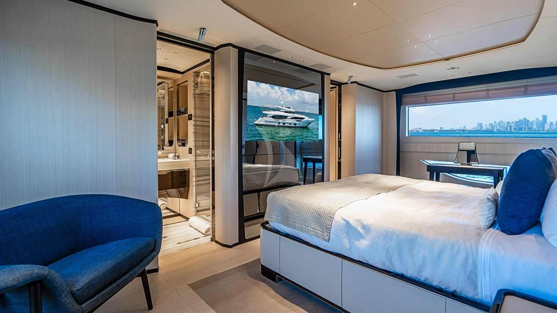 a room with a bed and a chair aboard BELLA VITA Yacht for Charter