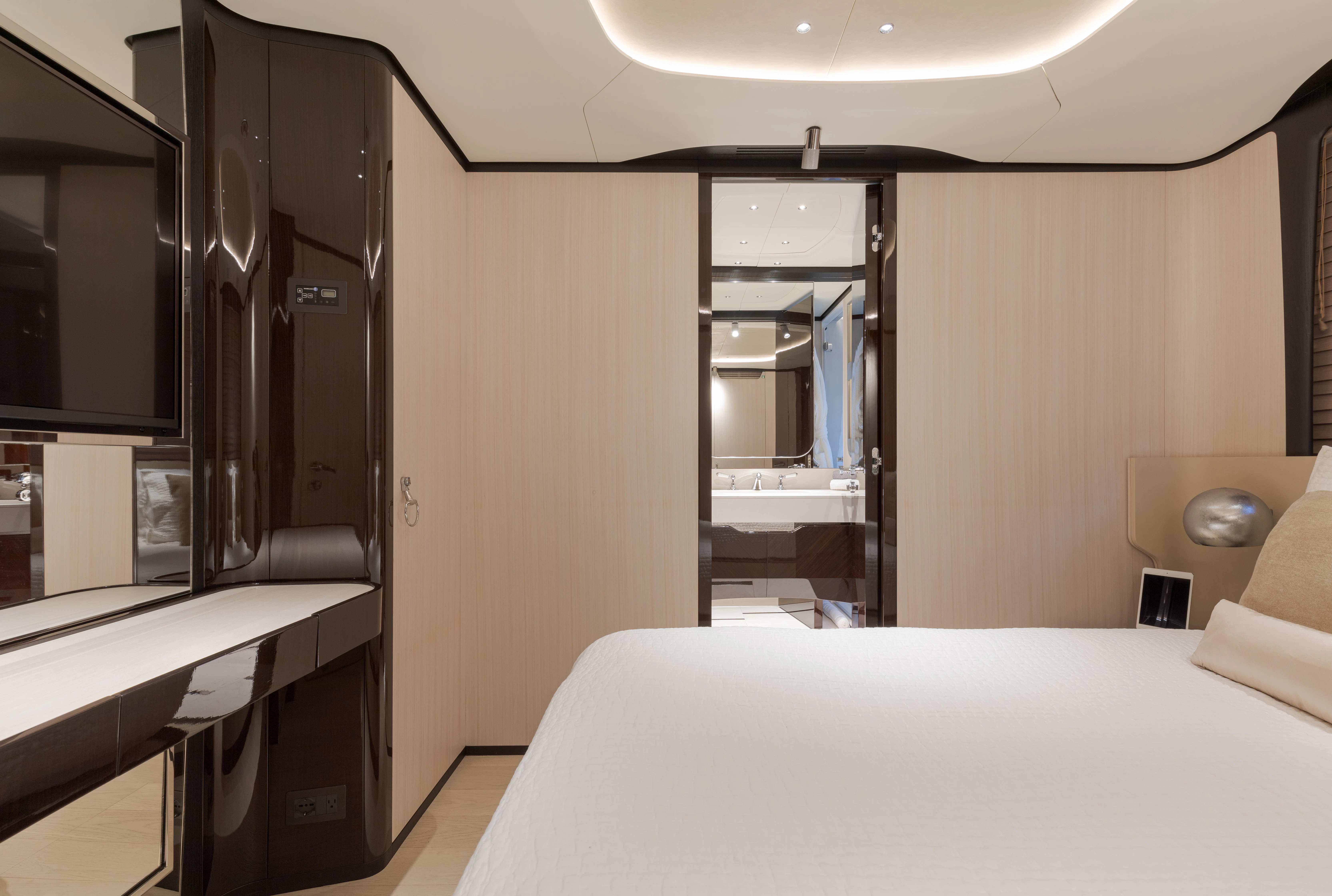 a room with a bed and a desk aboard BELLA VITA Yacht for Charter