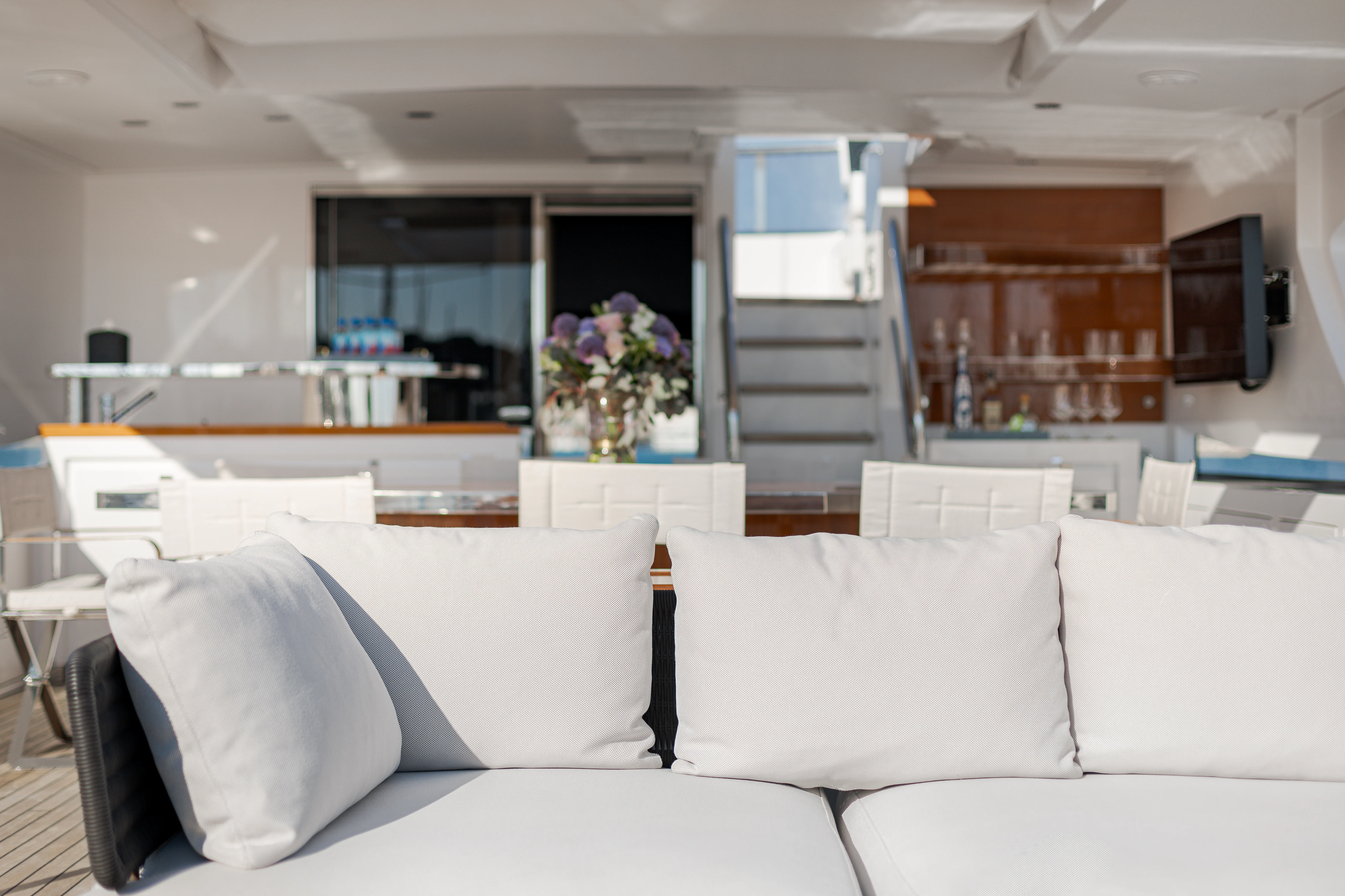 a living room with white couches aboard BELLA VITA Yacht for Charter