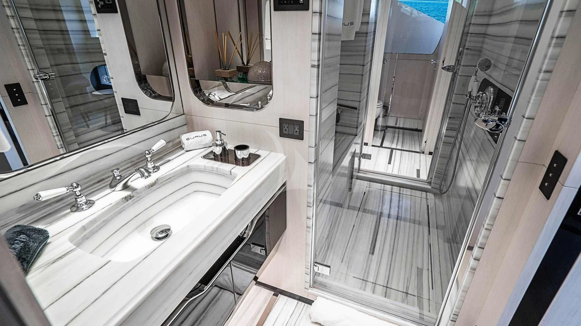 a bathroom with a sink and a large mirror aboard BELLA VITA Yacht for Charter