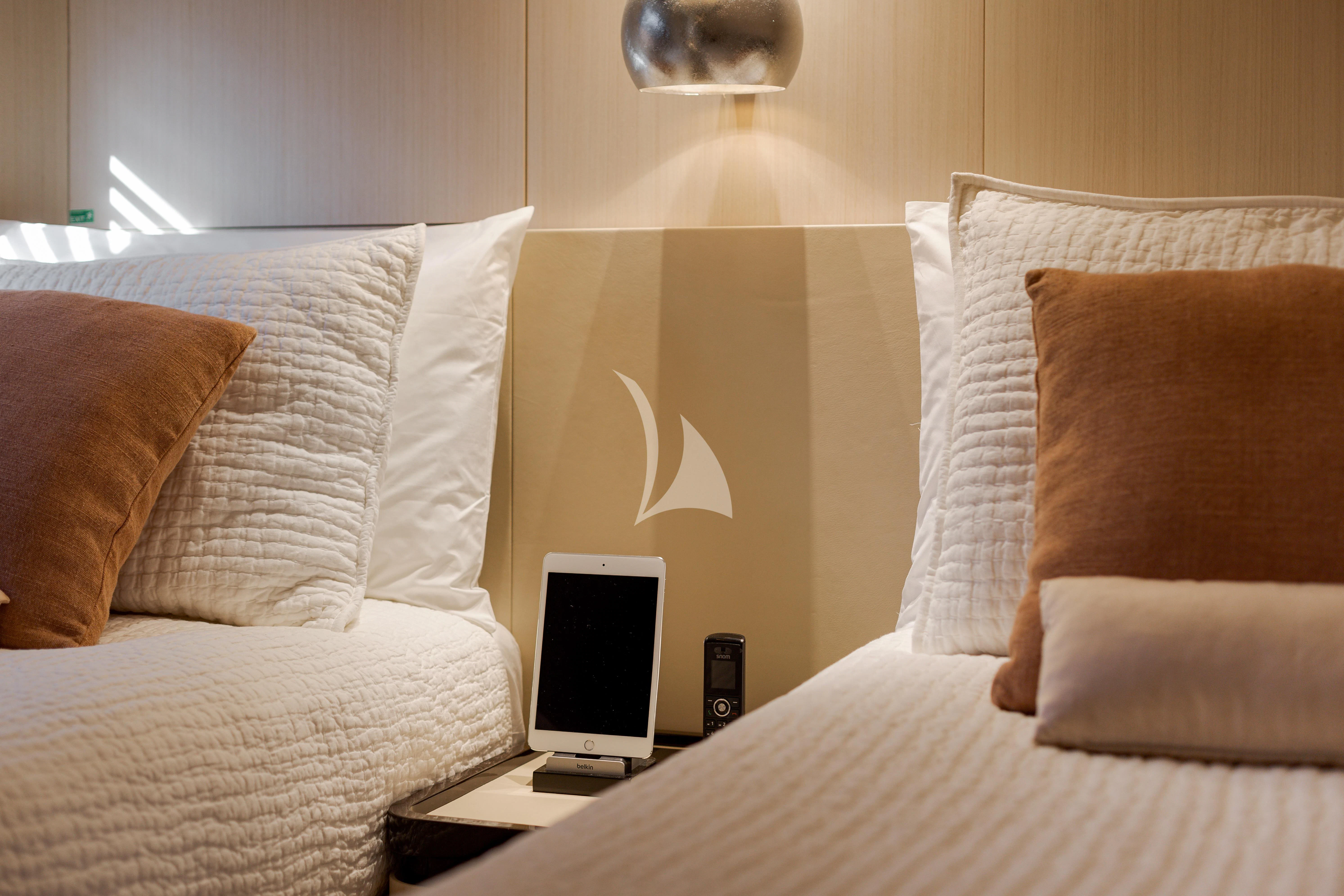 a bed with a television on it aboard BELLA VITA Yacht for Charter