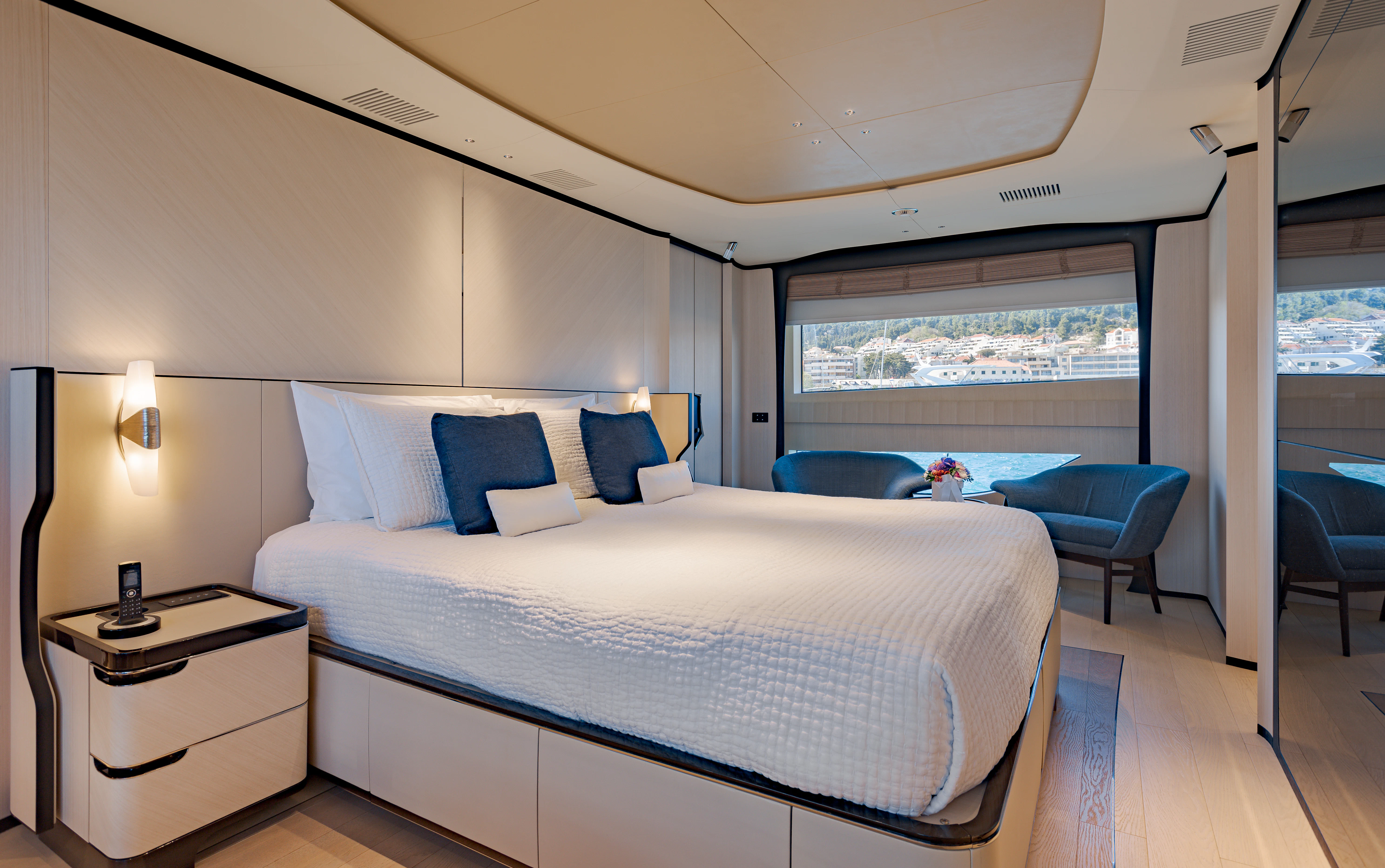 a bedroom with a bed and a window aboard BELLA VITA Yacht for Charter