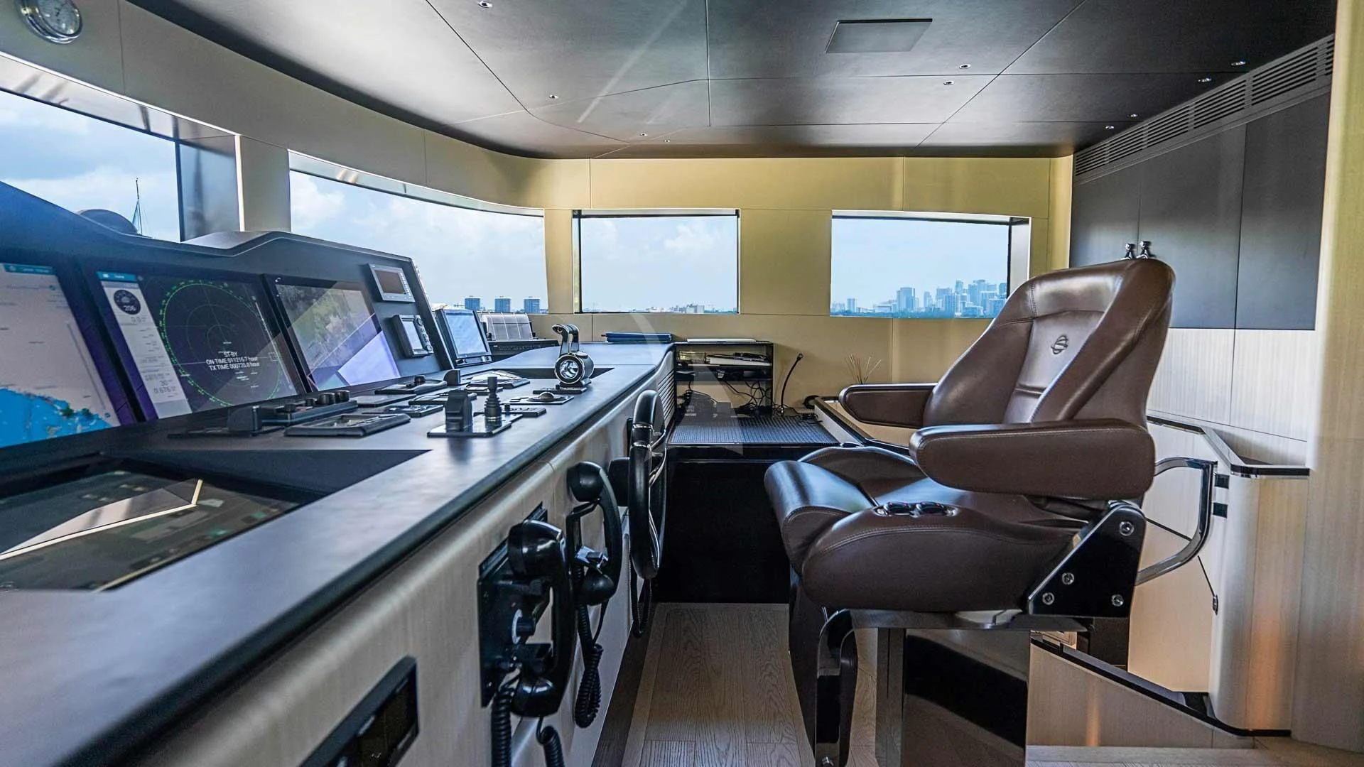 a room with a desk and chairs aboard BELLA VITA Yacht for Charter
