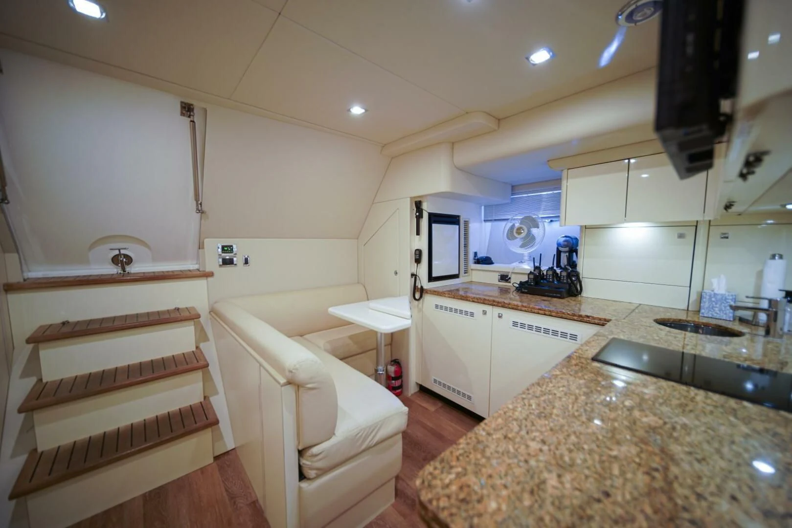 a kitchen with a sink and a staircase aboard EL TIO Yacht for Sale