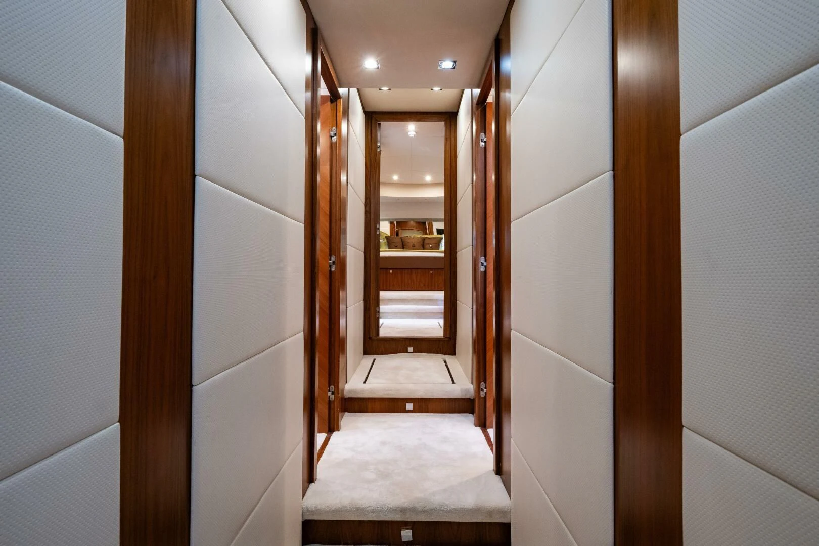 a hallway with a wood door aboard EL TIO Yacht for Sale