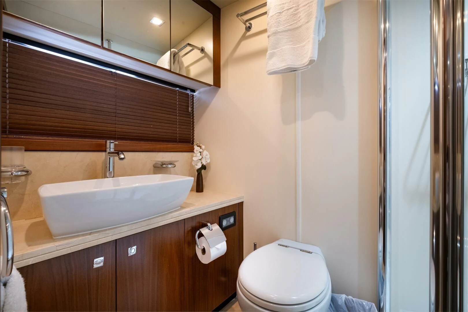 a bathroom with a sink toilet and a mirror aboard EL TIO Yacht for Sale