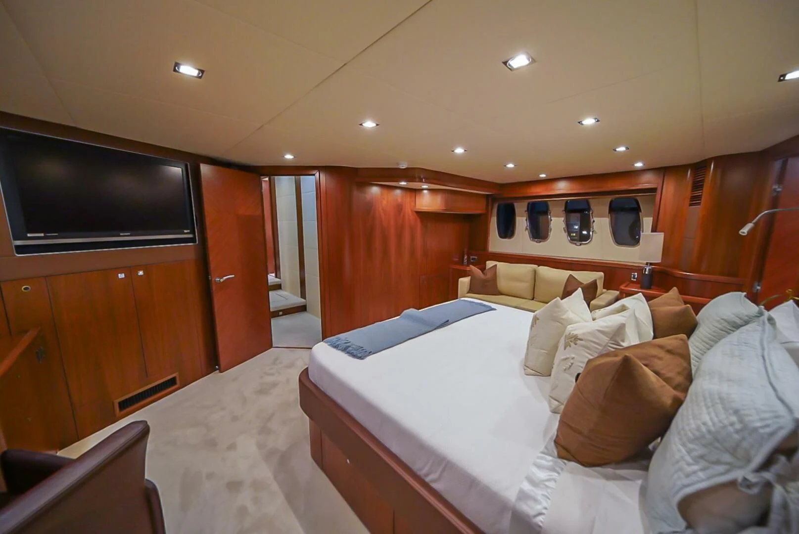 a room with a bed and a television aboard EL TIO Yacht for Sale
