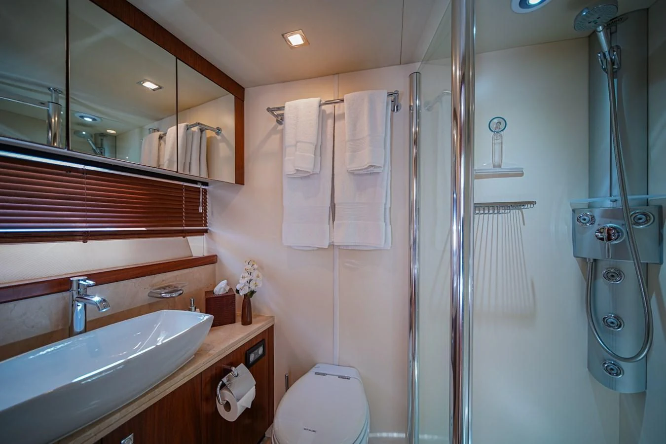 a bathroom with a glass shower aboard EL TIO Yacht for Sale