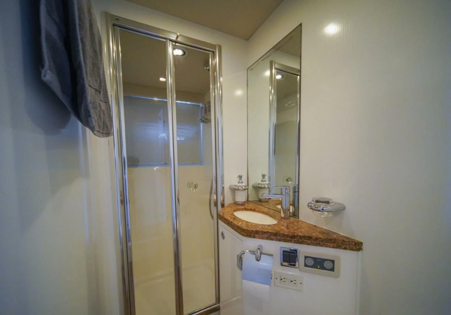 a bathroom with a glass shower door aboard EL TIO Yacht for Sale