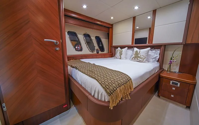 a bed in a room aboard EL TIO Yacht for Sale