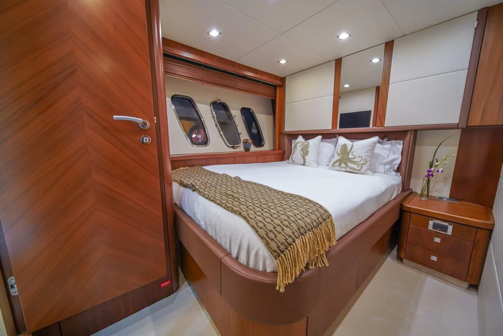 a bedroom with a bed and a mirror aboard EL TIO Yacht for Sale