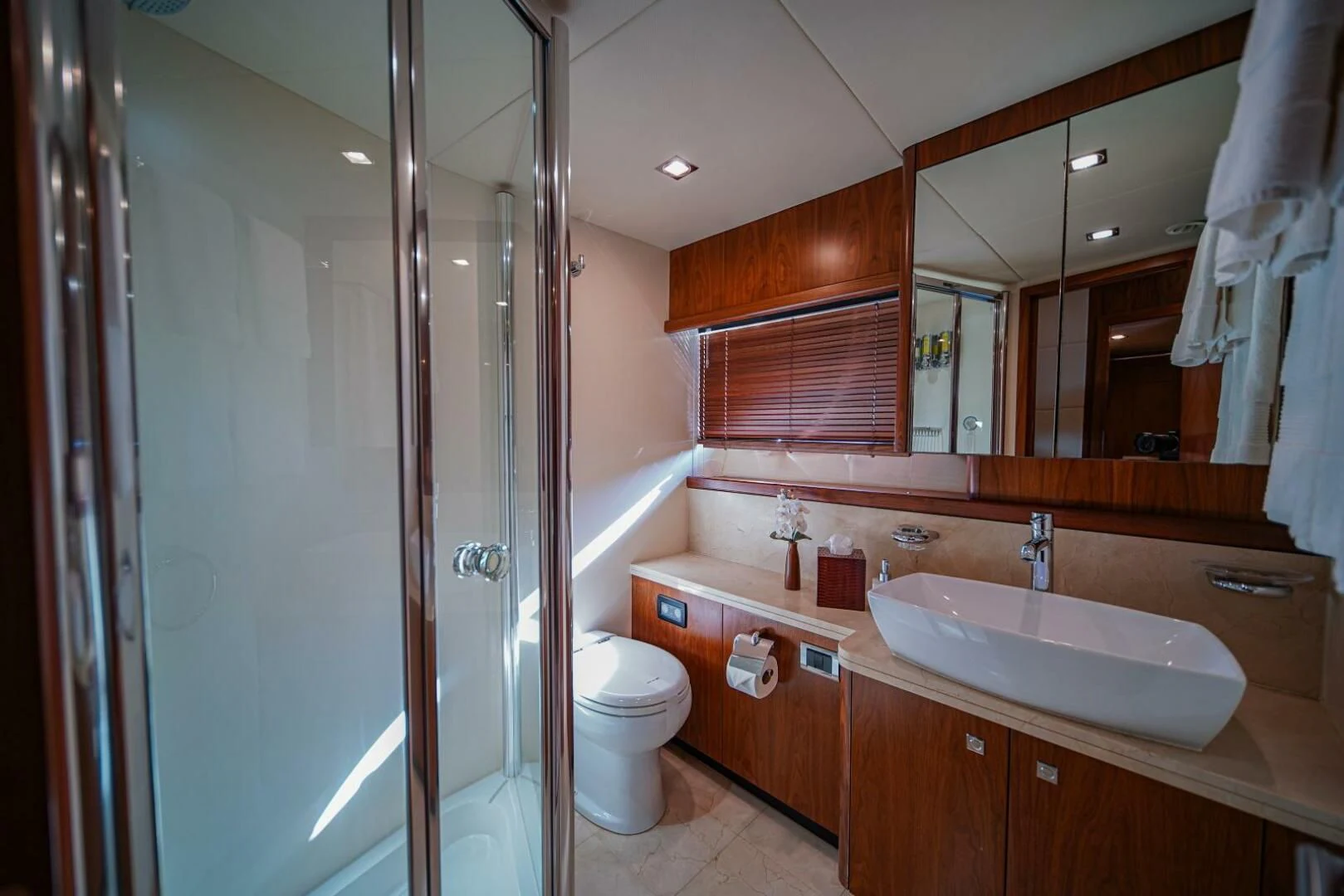 a bathroom with a glass shower aboard EL TIO Yacht for Sale