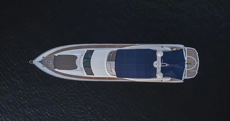 a silver and blue boat aboard EL TIO Yacht for Sale