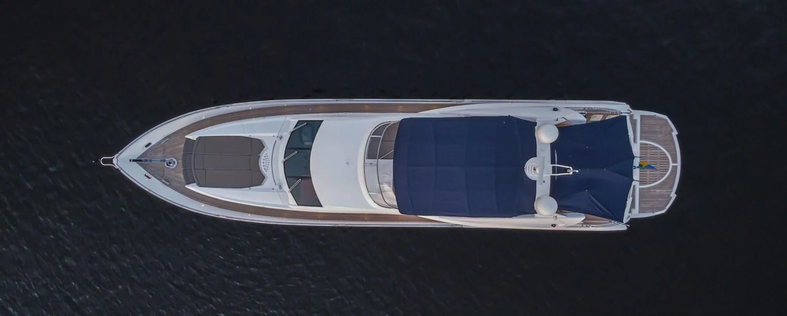 a white and blue car aboard EL TIO Yacht for Sale