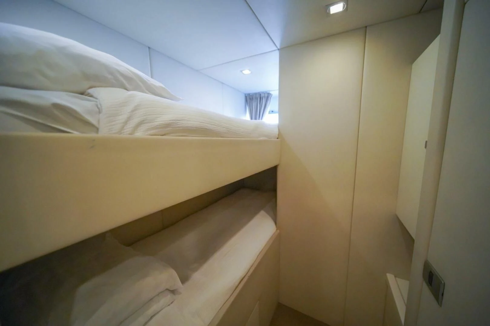 a room with a bed and a window aboard EL TIO Yacht for Sale