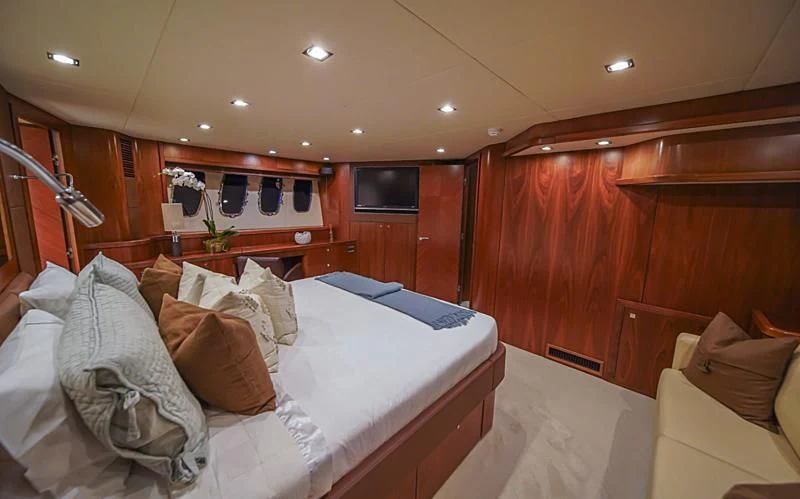 a room with a bed and a wood wall aboard EL TIO Yacht for Sale