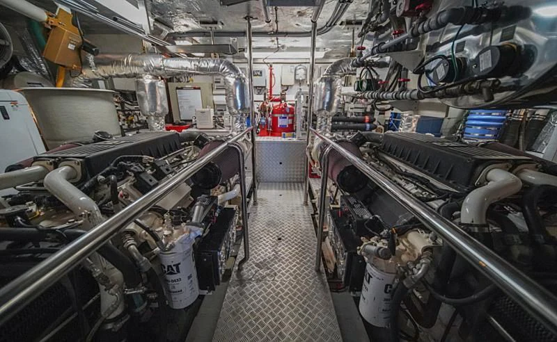 a room with many pipes and machinery aboard EL TIO Yacht for Sale