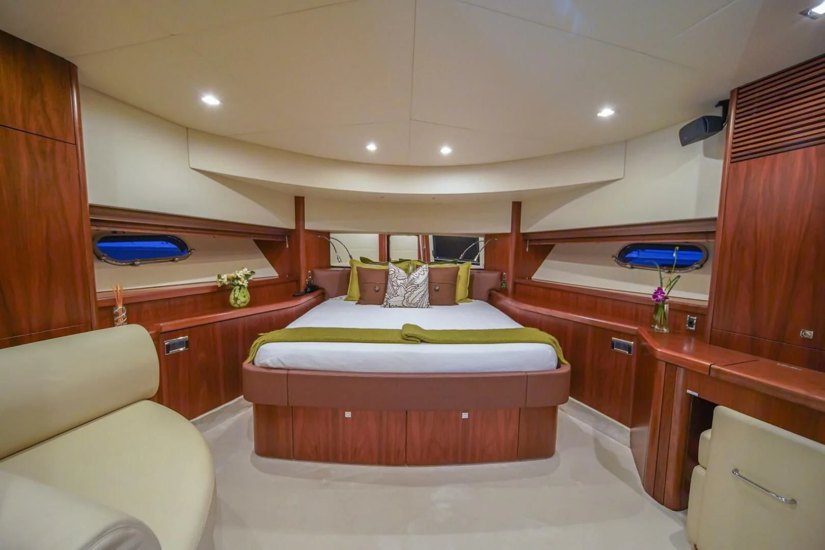 a bedroom with a bed and a chair aboard EL TIO Yacht for Sale