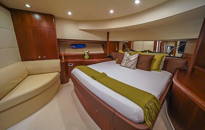 a room with a bed and a couch aboard EL TIO Yacht for Sale