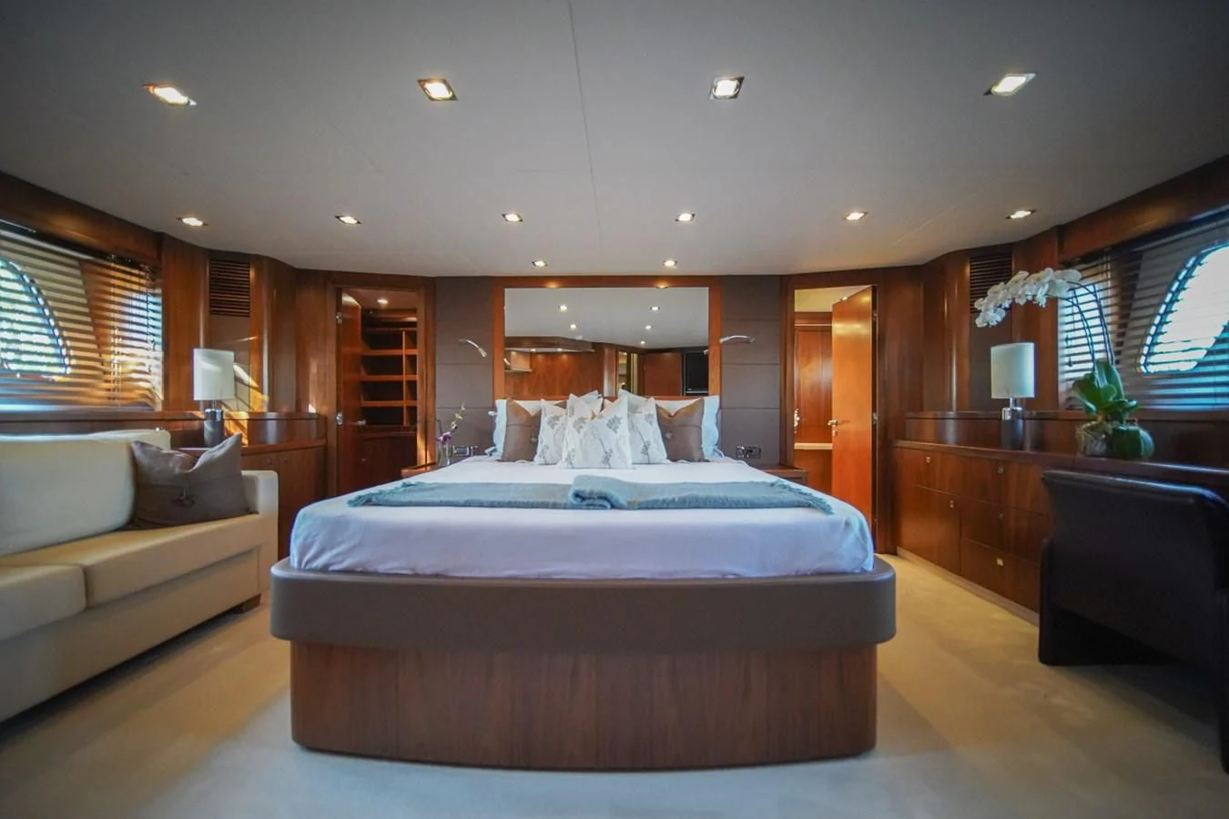a bedroom with a bed and a couch aboard EL TIO Yacht for Sale