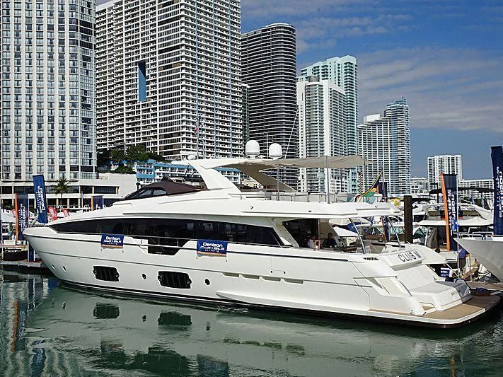 a white boat in a harbor aboard CLUB M Yacht for Sale