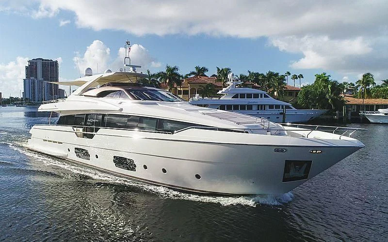a white yacht on a beach aboard CLUB M Yacht for Sale