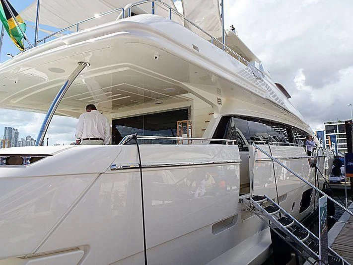 a large white boat with a person standing on the deck aboard CLUB M Yacht for Sale