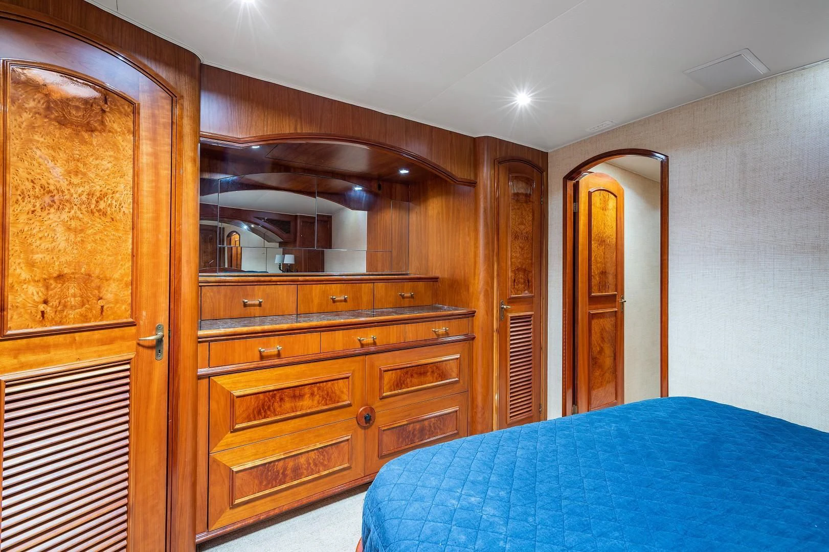 a bedroom with a bed and a closet aboard PAST TIME Yacht for Sale