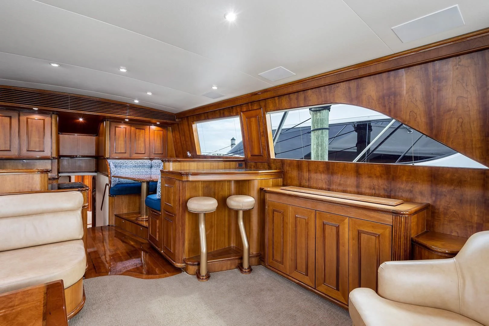 a room with wooden cabinets and a large window aboard PAST TIME Yacht for Sale