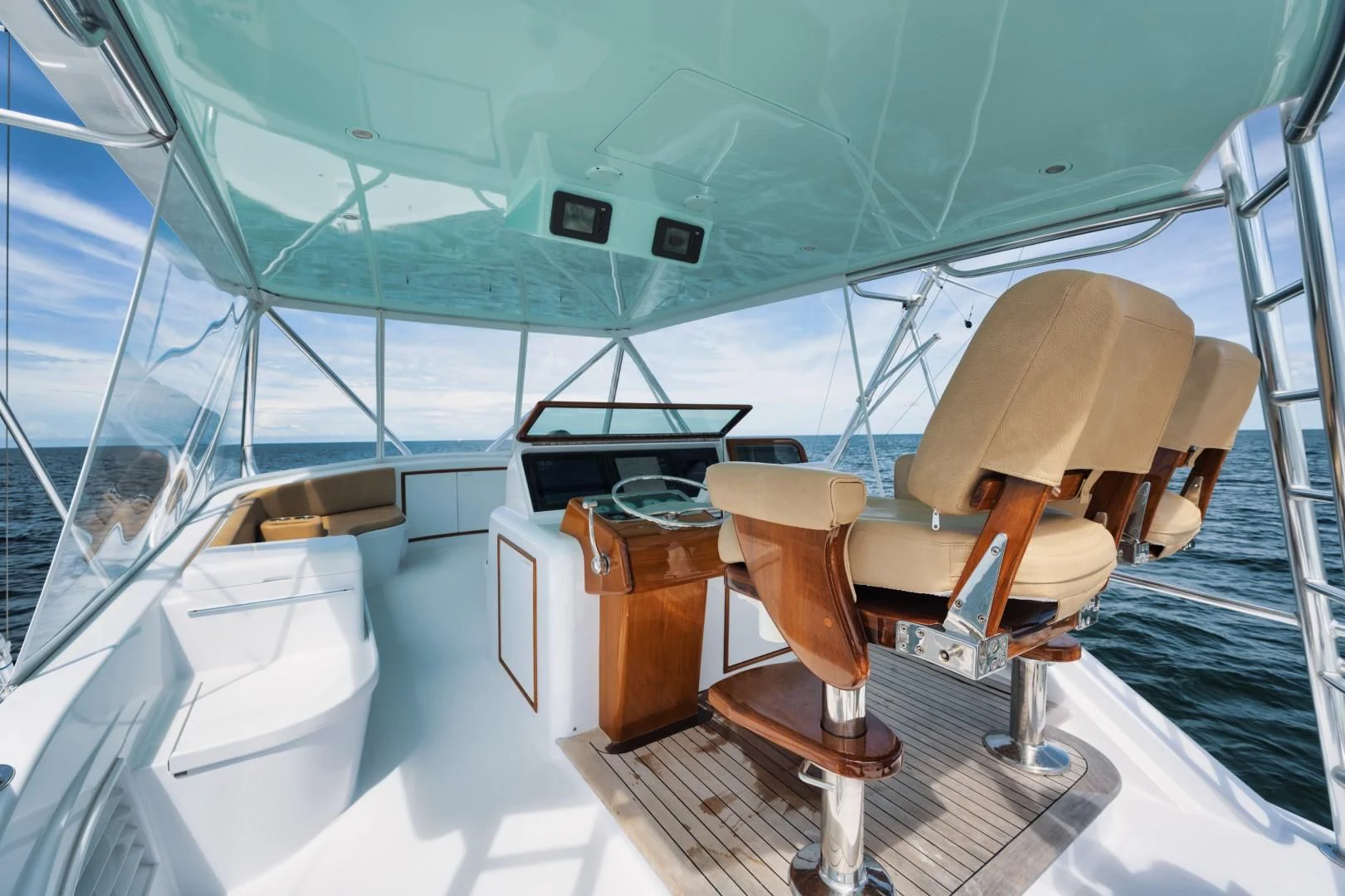 a boat with a seat and a table on the deck aboard PAST TIME Yacht for Sale