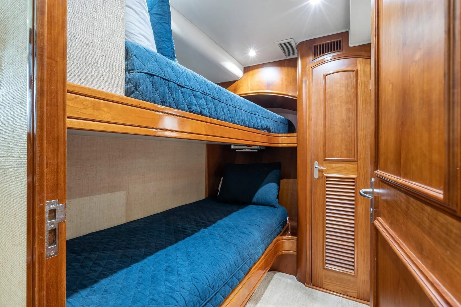 a bed with a blue sheet aboard PAST TIME Yacht for Sale