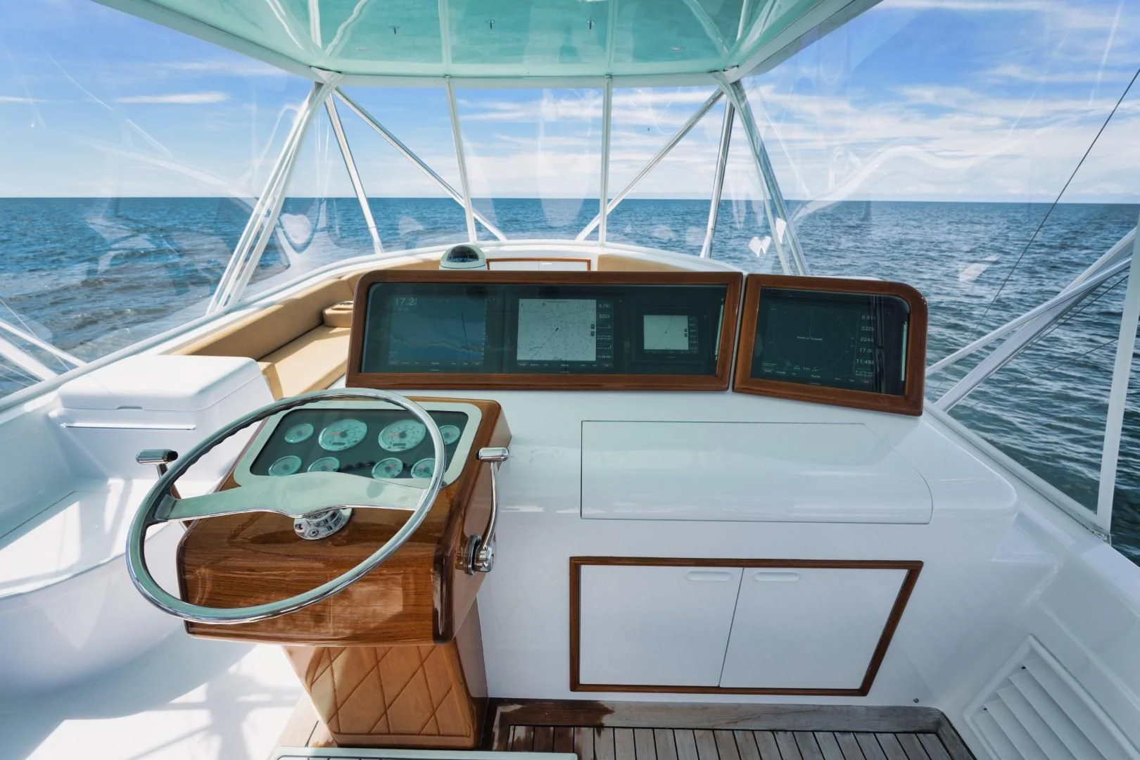 a boat with a steering wheel and a ship in the background aboard PAST TIME Yacht for Sale