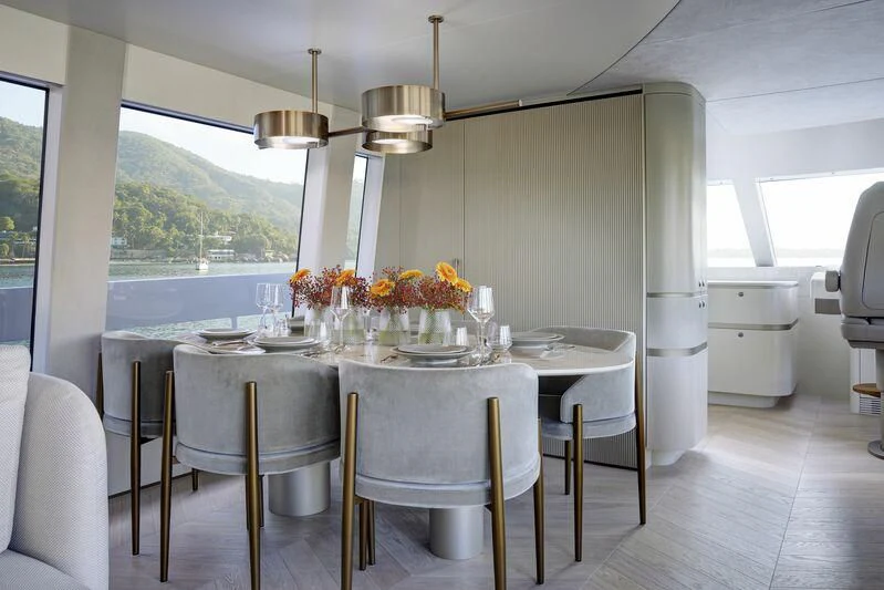 a kitchen with a table and chairs aboard DUTCH FALCON Yacht for Sale