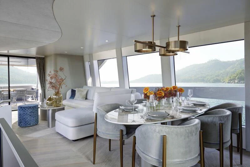 a dining table in a living room aboard DUTCH FALCON Yacht for Sale