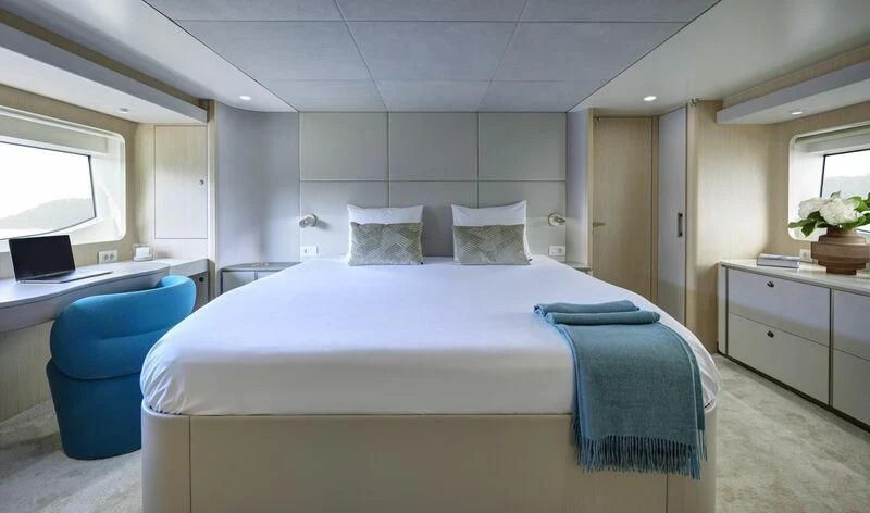 a bedroom with a bed and a desk aboard DUTCH FALCON Yacht for Sale