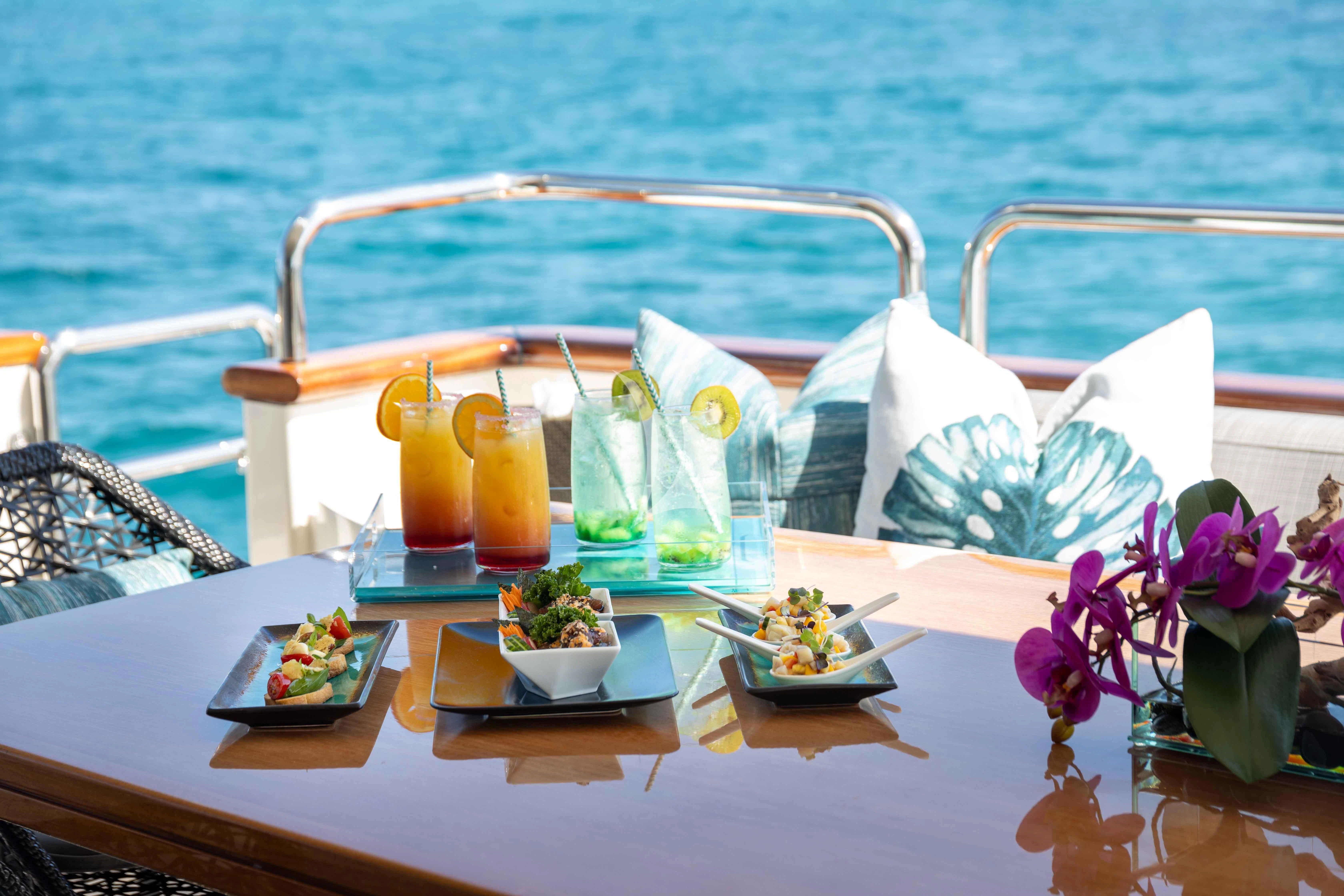 a table with food and drinks on it aboard INSIEME Yacht for Sale