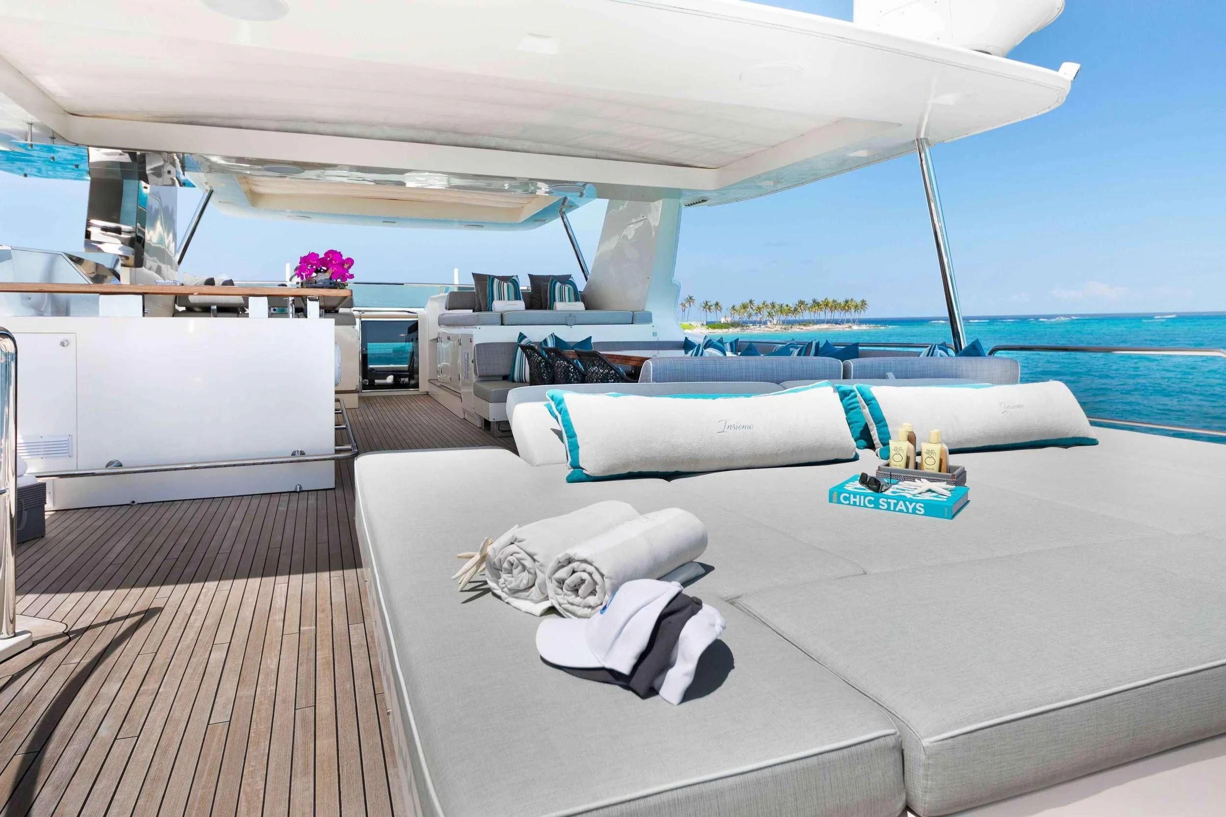 a room with a bed and a table and a large body of water aboard INSIEME Yacht for Sale
