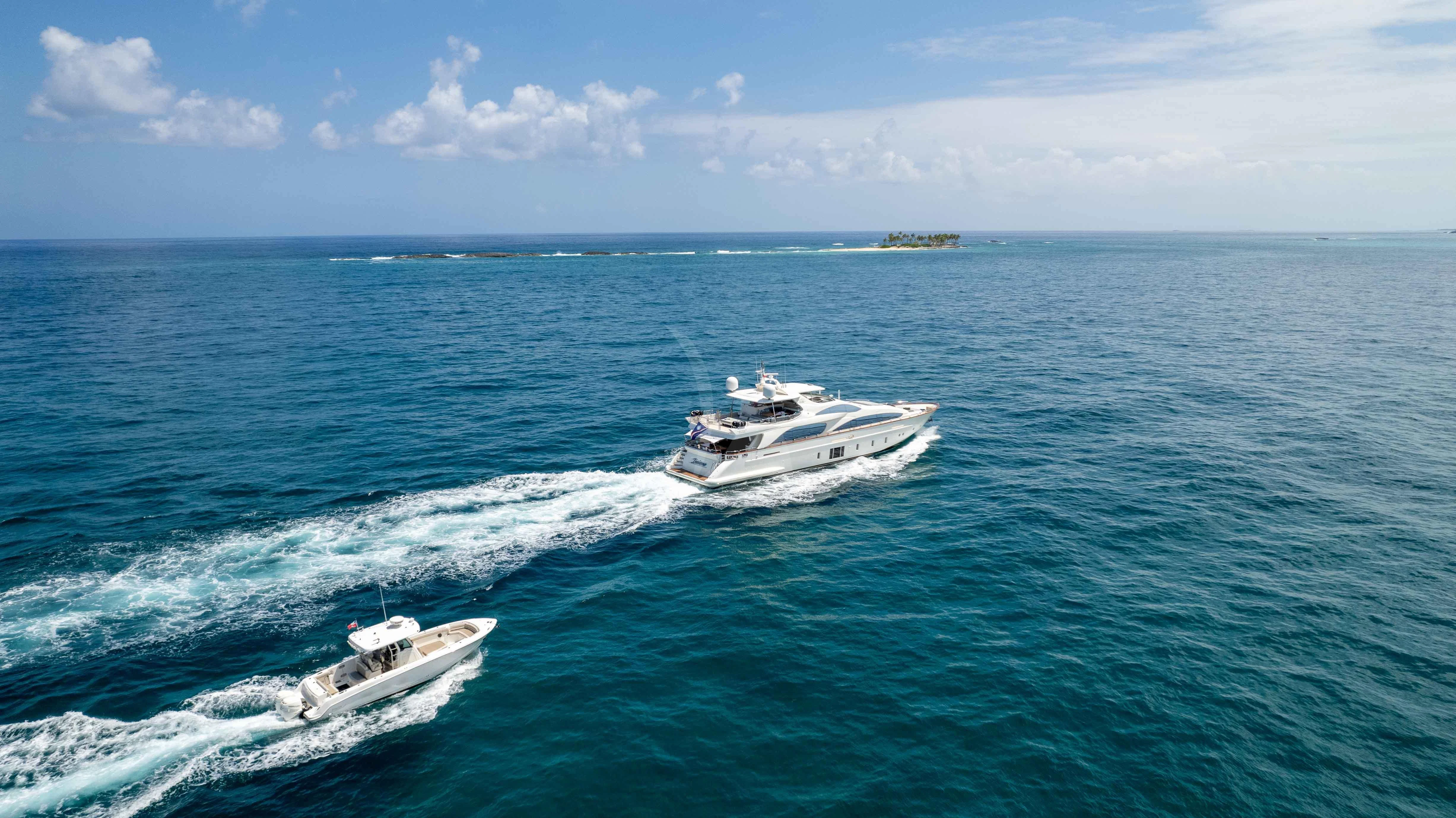a couple of boats in the ocean aboard INSIEME Yacht for Sale