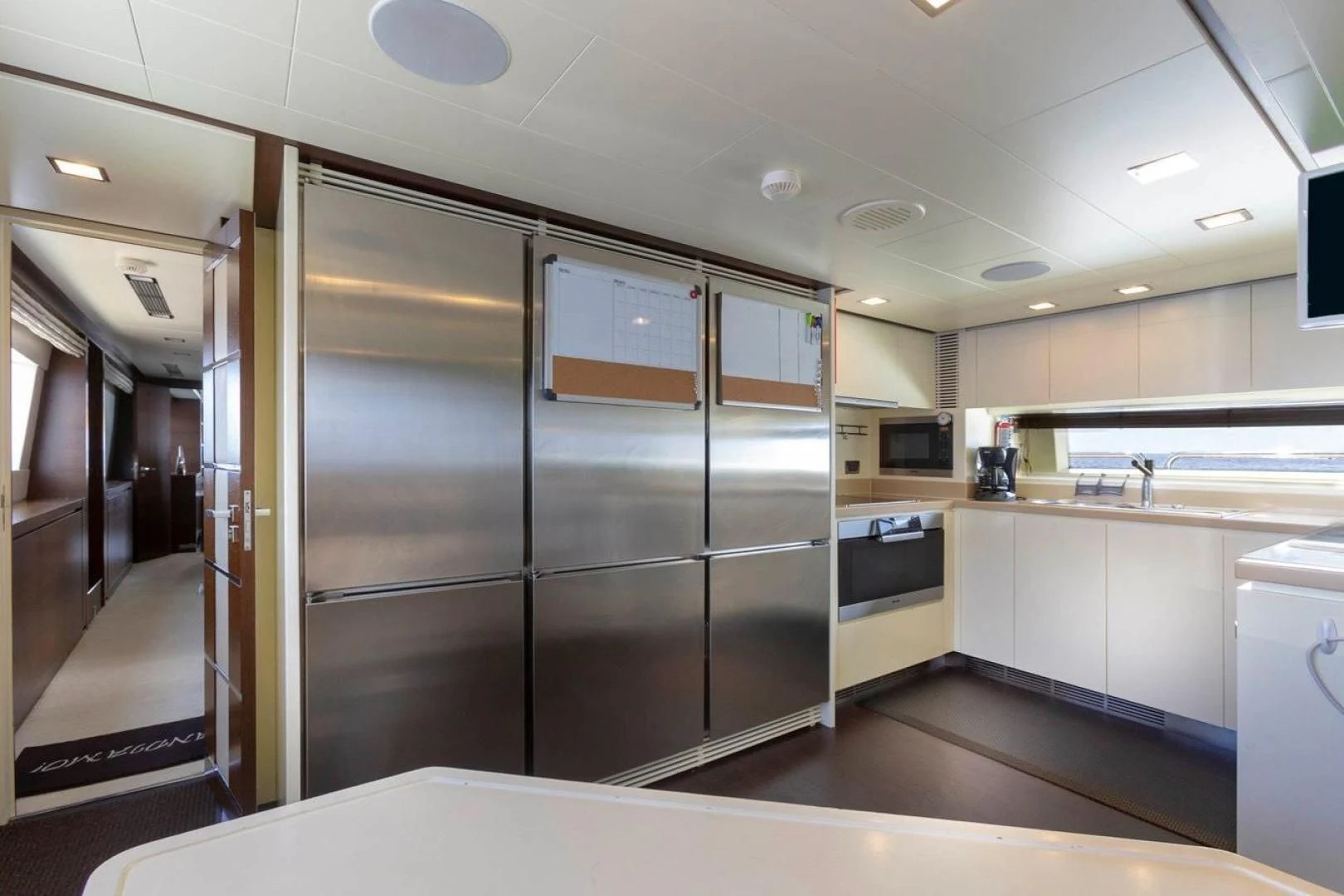 a large kitchen with stainless steel appliances aboard INSIEME Yacht for Sale